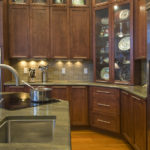 A kitchen with wooden cabinets and a sink