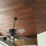 A house with a fan and lights with a wooden ceiling