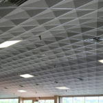 A ceiling with patterned carpeting and lights