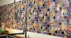 A colorful patterned wall with square tiles