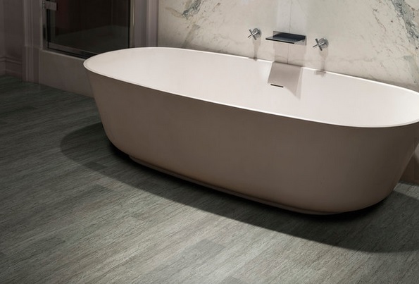 A polymeric flooring with a white bathtub