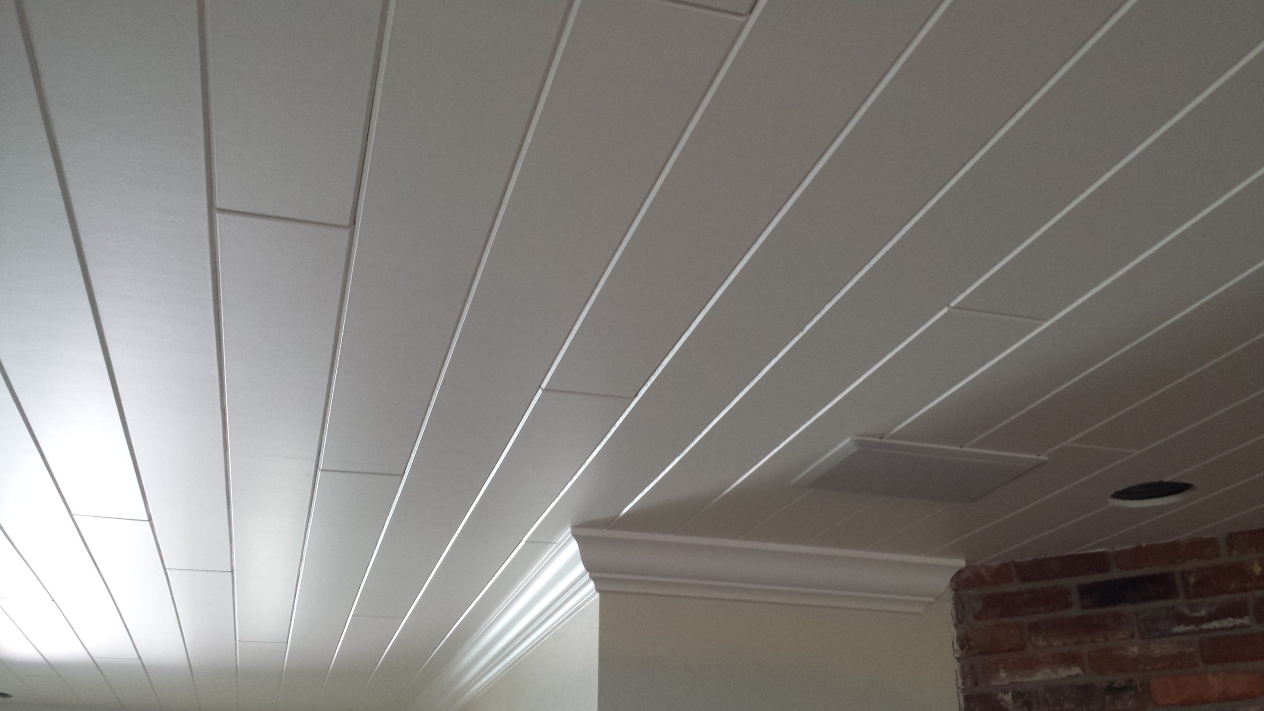 Plank work on a white ceiling of a house