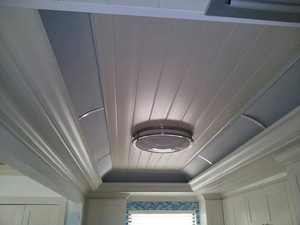 A boring ceiling with panels with a light