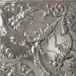 A corner of a ceiling with a silver floral pattern