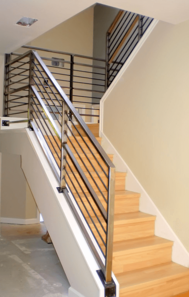 A Wooden Staircase With a Metallic Staircase