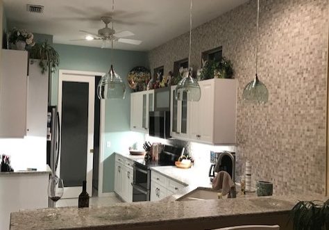 A kitchen makeover with two dining chairs